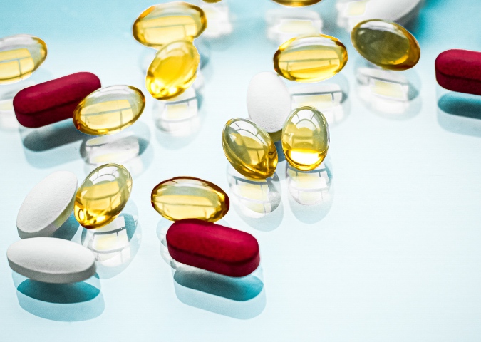 A variety of vitamins and pills scattered on a table.